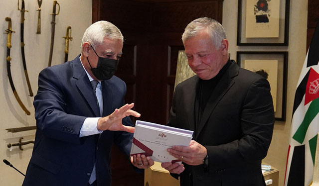His Majesty King Abdullah receives a copy of the Judicial Council’s 2020 report from the council president, Mohammad Ghazou, on Monday (Photo courtesy of Royal Court)